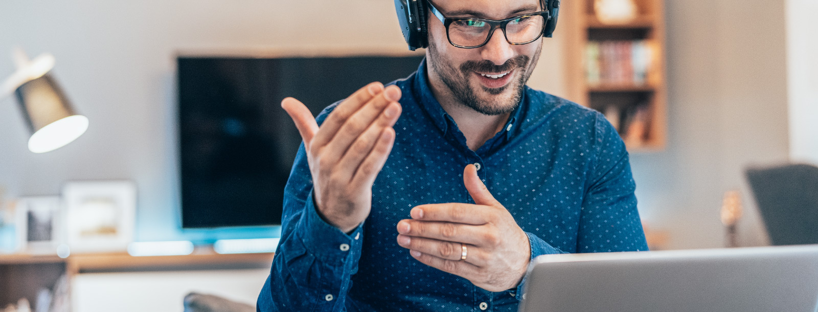 Business man discusses idea to team through his computer.