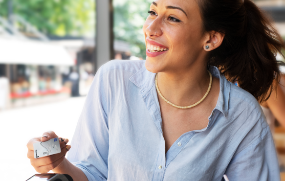 Young woman makes a payment with her Commercial Bank Visa credit card.